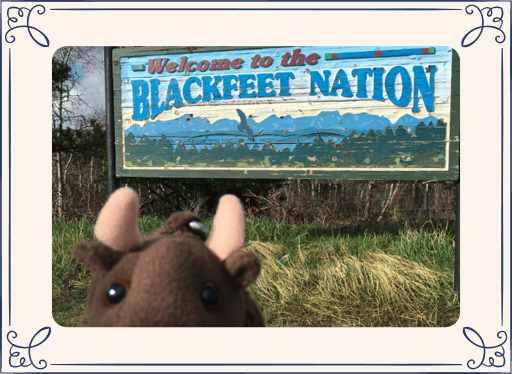 Buddy Bison plush in front of Blackfeet Nation sign