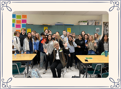 Dr. Holland and high school kids in a classroom making silly faces